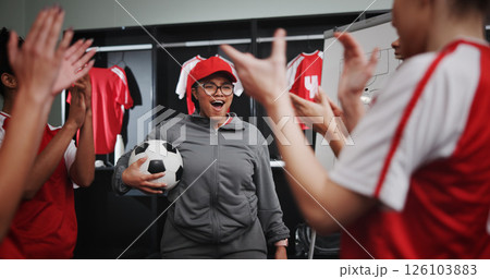 Women, coach and celebration with soccer team or applause for winning or victory in locker room. Female people, group or sport players clapping with smile for leadership, match or game achievement Women, coach and celebration with soccer team or applause for winning or victory in locker room. Female people, group or sport players clapping with smile for leadership, match or game achievement 126103883