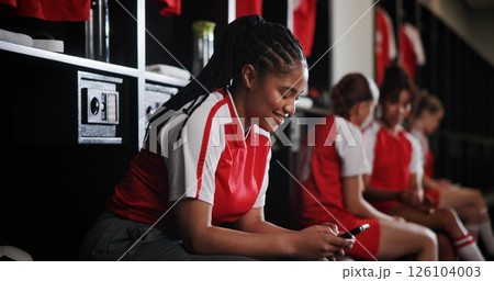 Sports, soccer and happy woman with phone in locker room for social media, contact and communication. Athlete, football and person relax on smartphone for match, training and tournament schedule Sports, soccer and happy woman with phone in locker room for social media, contact and communication. Athlete, football and person relax on smartphone for match, training and tournament schedule 126104003