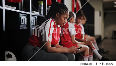 Sports, texting and woman with smartphone, locker room and communication on social media and online. Gym, soccer player and person with mobile for chat, typing and girl with sportswear for match Sports, texting and woman with smartphone, locker room and communication on social media and online. Gym, soccer player and person with mobile for chat, typing and girl with sportswear for match 126104009