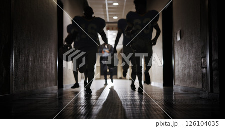 Light, football and running and team in corridor for sports competition, stadium match and game. Fitness, pro league player and athlete with people in tunnel for training, tournament and contest 126104035