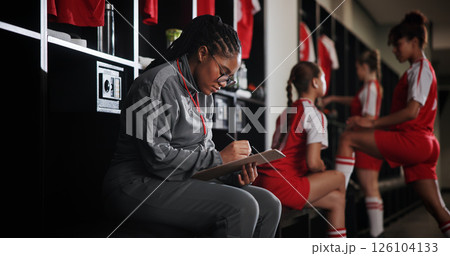 Woman, soccer coach and writing with clipboard for checklist, game plan or attendance list in locker room. Female person, manager or coordinator with notes for match, sport or player registration Woman, soccer coach and writing with clipboard for checklist, game plan or attendance list in locker room. Female person, manager or coordinator with notes for match, sport or player registration 126104133