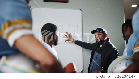 Board, teamwork and football with coach and men in locker room for game plan, sports strategy or defense formation. Touchdown tactics, match feedback and discussion with people and training advice 126104147