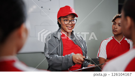 Women, coach and meeting with soccer team for game plan, strategy or discussion together. Female people, trainer or coordinator talking to group or players with clipboard for sport match or formation 126104167