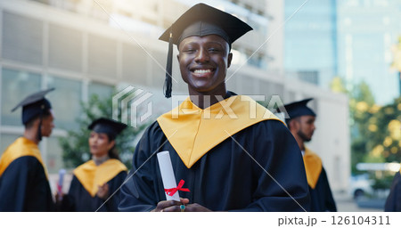 Man, student and graduation with diploma in city, education and pride for achievement at college campus. Person, excited and certificate for learning, scholarship or outdoor in portrait at university 126104311