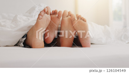People, feet and relax in bed with love, lazy weekend and romantic getaway in hotel. Couple, toes and sleeping in resort bedroom with touch, comfort or relationship development with trust in marriage People, feet and relax in bed with love, lazy weekend and romantic getaway in hotel. Couple, toes and sleeping in resort bedroom with touch, comfort or relationship development with trust in marriage 126104549