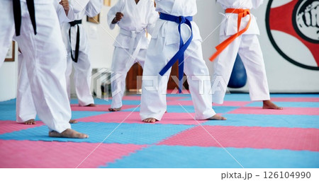 Karate, kids and legs at dojo for fighting, self defense or fitness training together. Practice, children and body of students with kicking exercise for martial arts, workout or aikido lesson at gym. Karate, kids and legs at dojo for fighting, self defense or fitness training together. Practice, children and body of students with kicking exercise for martial arts, workout or aikido lesson at gym. 126104990
