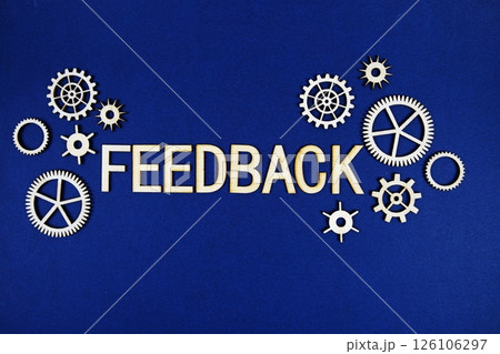 Feedback alphabet letters with gears element on navy blue background 126106297