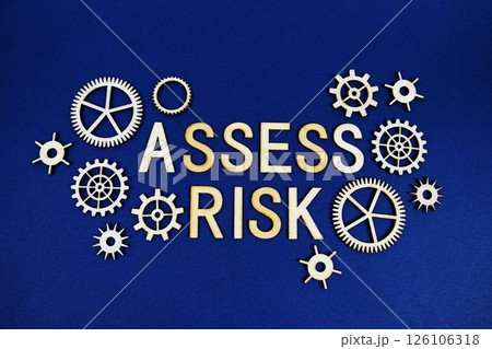 Assess Risk alphabet letters with gears element on navy blue background Assess Risk alphabet letters with gears element on navy blue background 126106318