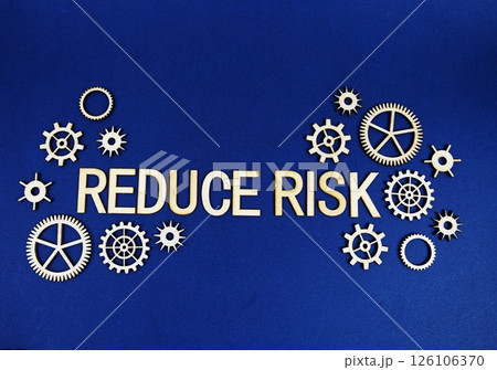 Reduce Risk alphabet letters with gears element on navy blue background 126106370