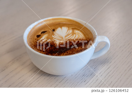 A cup of coffee with latte art, on the table A cup of coffee with latte art, on the table 126106452