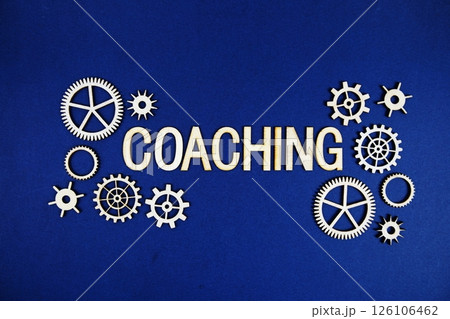 Coaching alphabet letters with gears element on navy blue background Coaching alphabet letters with gears element on navy blue background 126106462