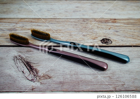 Toothbrushes flat lay on wooden background 126106588