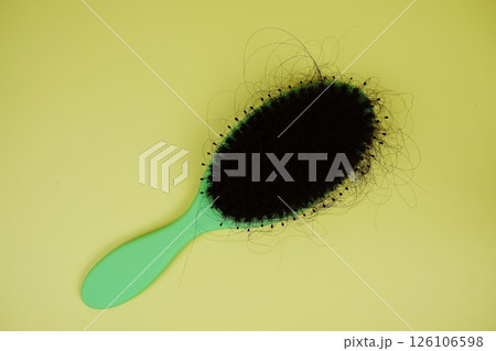 Comb Brush With Hair Fall on yellow background Comb Brush With Hair Fall on yellow background 126106598