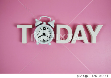 Today alphabet letters with alarm clock on pink background Today alphabet letters with alarm clock on pink background 126106631