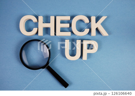 Check up text message and magnifying glass on blue background Check up text message and magnifying glass on blue background 126106640