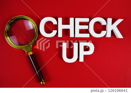 Check up text message and magnifying glass on red background 126106641