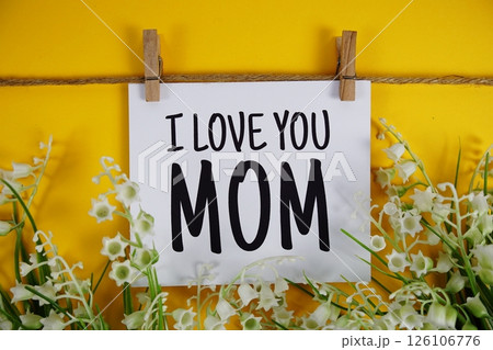 Happy Mother's Day text on paper card with flower blooming decoration on yellow background 126106776
