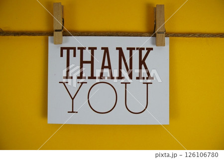 Thank You text on paper card on yellow background Thank You text on paper card on yellow background 126106780