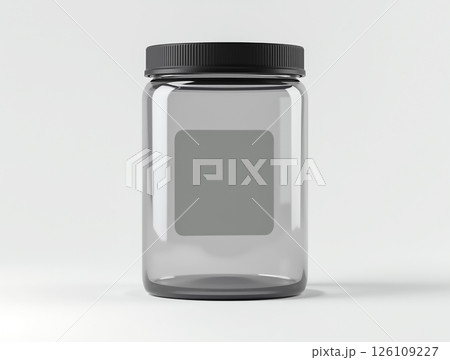 Clear glass jar with black lid on a plain background suitable for storage or packaging 126109227
