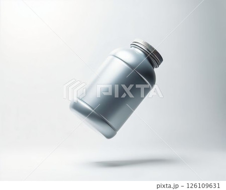 Silver bottle suspended in the air against a soft gradient background showcasing its sleek design 126109631