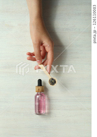 Lavender oil in a bottle on a light background 126110083