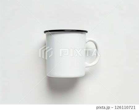 Plain white mug with black rim positioned on a light surface for a minimalist display 126110721