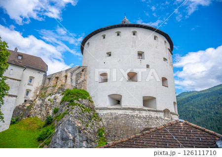 Nestled on a rocky hill, Kufstein Fortress showcases impressive medieval architecture against a backdrop of clear skies and lush green mountains, inviting visitors to discover its historic charm. Nestled on a rocky hill, Kufstein Fortress showcases impressive medieval architecture against a backdrop of clear skies and lush green mountains, inviting visitors to discover its historic charm. 126111710