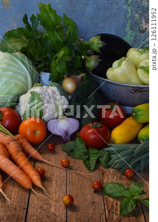 Assortment of colorful fresh vegetables including cabbage carrots and tomatoes on a rustic background ideal for vegetarian recipes organic market visuals and healthy lifestyle promotions Assortment of colorful fresh vegetables including cabbage carrots and tomatoes on a rustic background ideal for vegetarian recipes organic market visuals and healthy lifestyle promotions 126111952