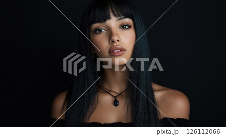 portrait of a young woman with long, straight black hair. She has a serious expression on her face and is looking directly at the camera.	 126112066