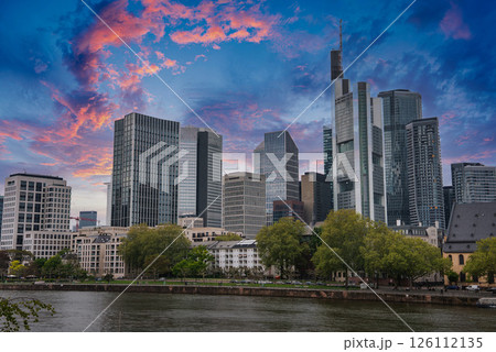 Modern skyline of Frankfurt, Germany, featuring the Commerzbank Tower, tree lined waterfront, and a mix of contemporary and historic architecture. Modern skyline of Frankfurt, Germany, featuring the Commerzbank Tower, tree lined waterfront, and a mix of contemporary and historic architecture. 126112135