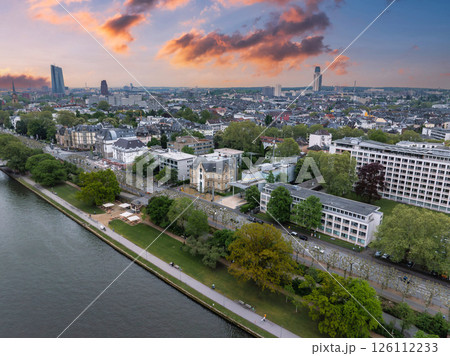 Aerial view of Frankfurt, Germany, during sunset. The Main River flows in the foreground, with the European Central Bank tower in the distance. Aerial view of Frankfurt, Germany, during sunset. The Main River flows in the foreground, with the European Central Bank tower in the distance. 126112233