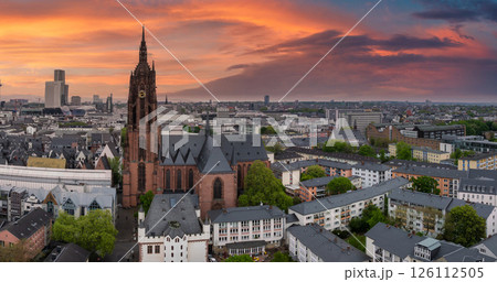Aerial view of Frankfurt, Germany, featuring the Gothic style Frankfurt Cathedral, vibrant sunset hues, modern high rises, and green urban spaces. Aerial view of Frankfurt, Germany, featuring the Gothic style Frankfurt Cathedral, vibrant sunset hues, modern high rises, and green urban spaces. 126112505
