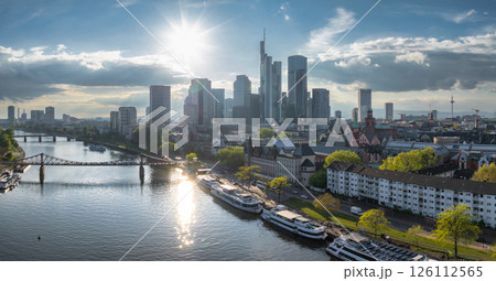 Aerial view of Frankfurt, Germany, featuring modern skyscrapers like Commerzbank Tower, the River Main, Eiserner Steg bridge, and the Fernsehturm. 126112565