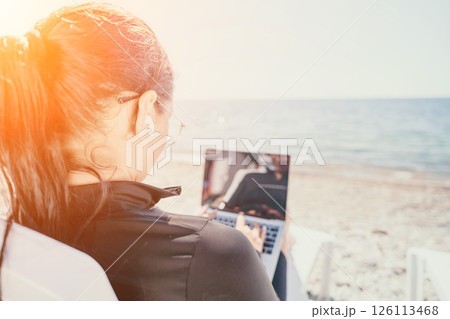 Woman Laptop Beach Working Remotely on Sandy Shore 126113468