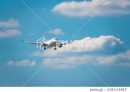 plane landing against a background of clouds 126114467