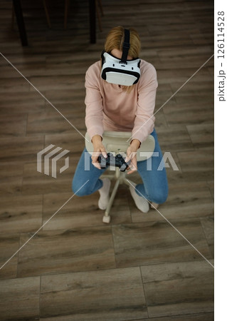 Immersive gaming experience on a serene afternoon in a cozy living room 126114528