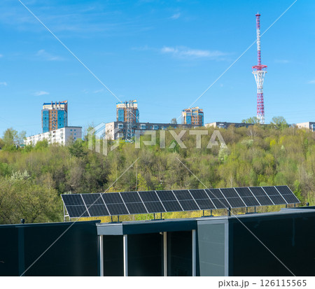 Solar panels installed on the roof of a modern apartment building in the city 126115565