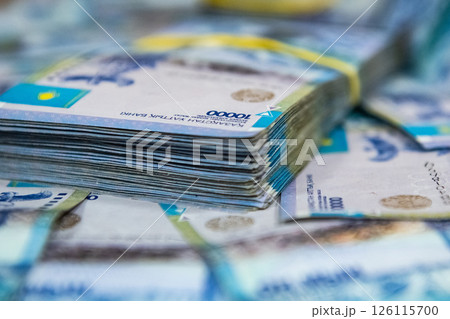 Thick wad of money cash on table 126115700