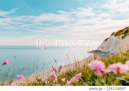 Beautiful summer beach with white sand blue water and pink flowers on cliff sunny seascape with floral foreground and scenic coastline concept of travel poster wellness branding tourism 126118097