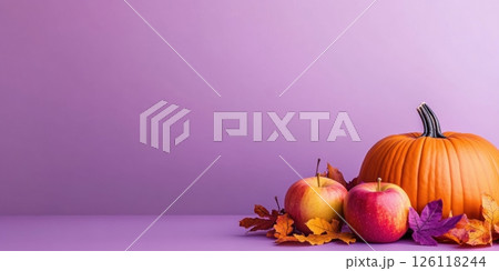 Orange pumpkin on a purple background surrounded by autumn maple leaves of red, orange and yellow colors. Apples are lying around. Suitable for articles about the season, pumpkin recipes, Halloween 126118244