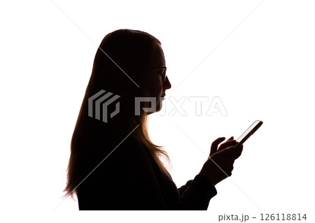 Silhouette of young woman using smartphone on white background 126118814