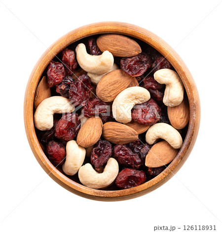 Cranberry almond cashew trail mix in a wooden bowl. Dried sweetened cranberries, mixed with raw almonds, and cashews. A popular snack food, rich on protein, and a good source of vitamins and minerals. 126118931