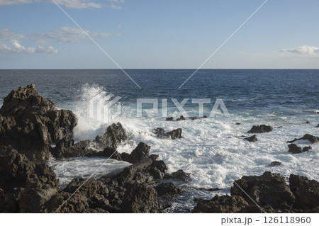 Waves Crashing Against black Lava Rocks on a Tropical Coast, water splashing at canary island Tenerife 126118960