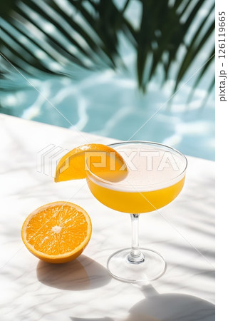 Vertical photo with fresh orange cocktail on the side of the pool, summer hotel vacation 126119665
