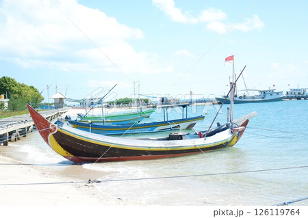Serene Beach Scene A Boat Resting on the Shore 126119764
