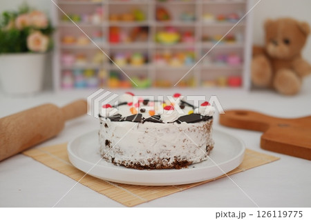 Delicious Birthday Cake with Cherries and Chocolate Decoration 126119775