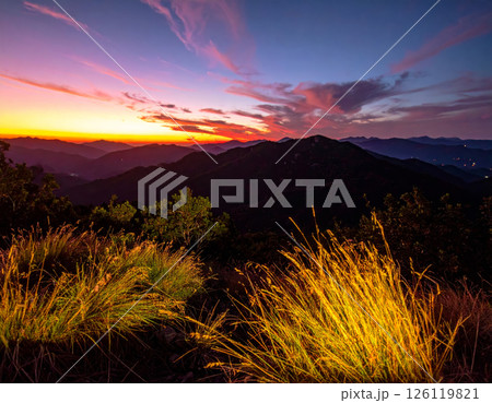 breathtaking sunset over mountain range, showcasing vibrant colors in sky and illuminated grass in foreground. scene evokes sense of tranquility and natural beauty breathtaking sunset over mountain range, showcasing vibrant colors in sky and illuminated grass in foreground. scene evokes sense of tranquility and natural beauty 126119821