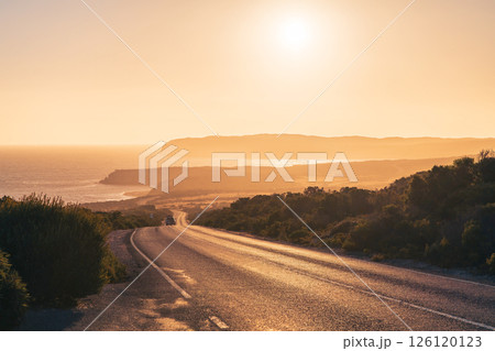 Beautiful winding road across the Innes National Park with car at sunset time 126120123