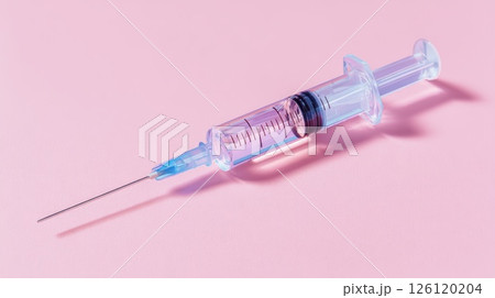 Medical Syringe on a Light Pink Background Displaying Injection Equipment 126120204