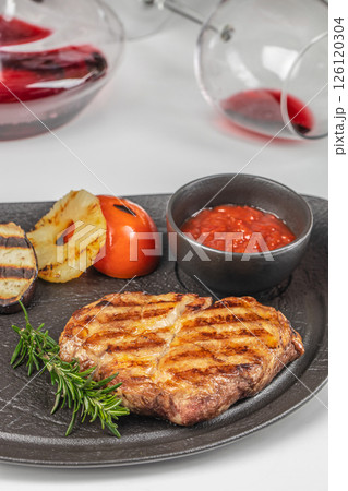 grilled pork steak with herbs and tomato sauce. Close up. top view 126120304